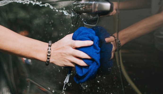 Microfiber towel washing a door handle